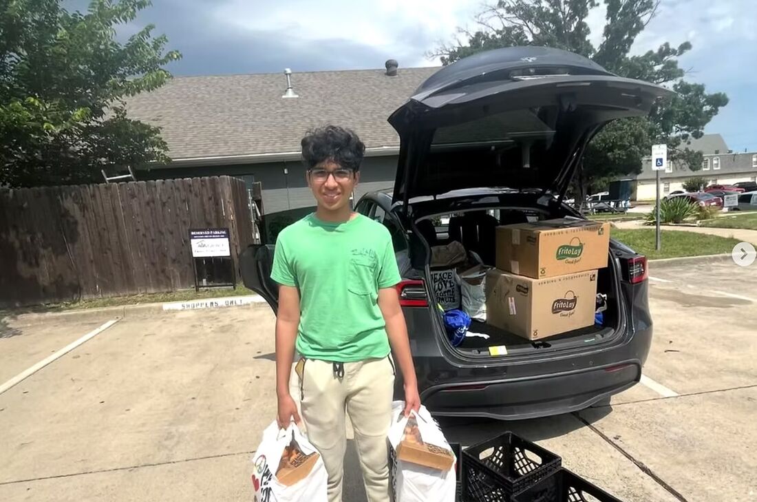 A volunteer loading boxes of rescued food into a car